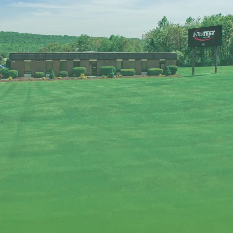 InterTest About Us sign and front lawn