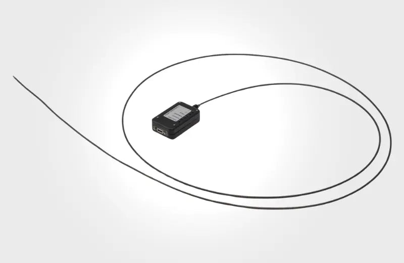 Small black rectangular USB-C video borescope with a probe on a white background