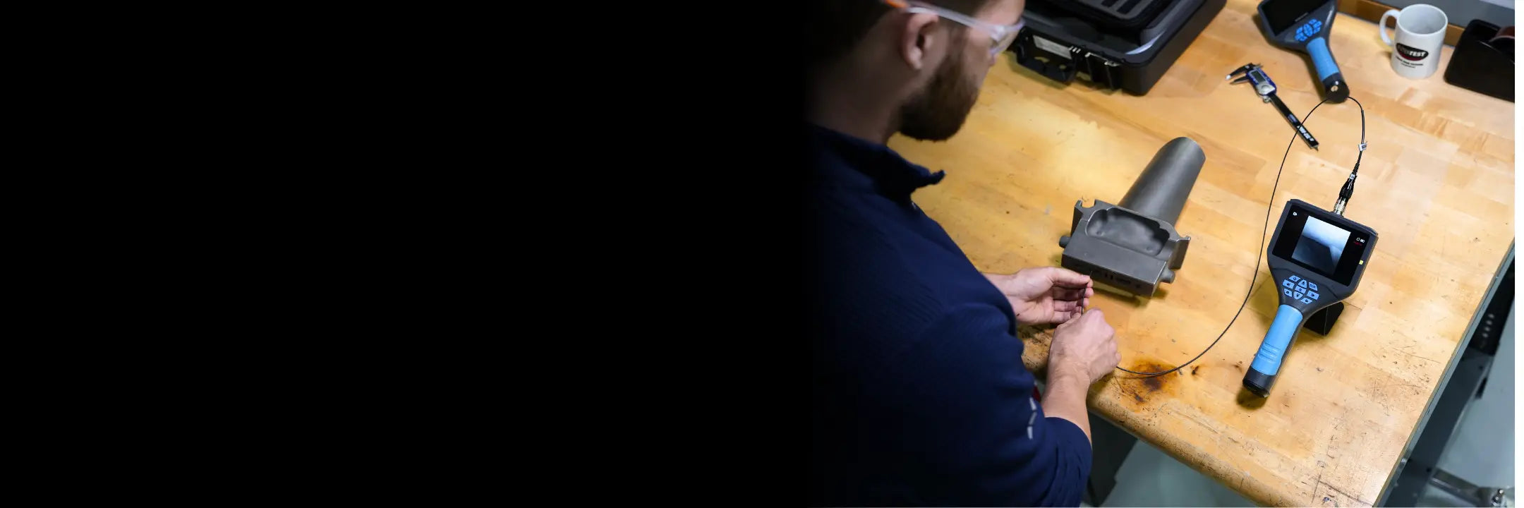 Inspector using a video borescope on a turbine part