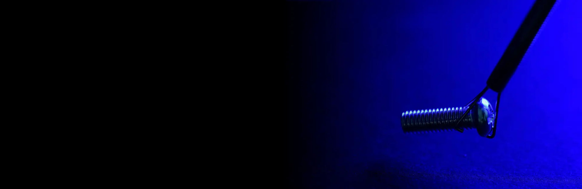 Retrieval tool picking up a small screw with blue led lights